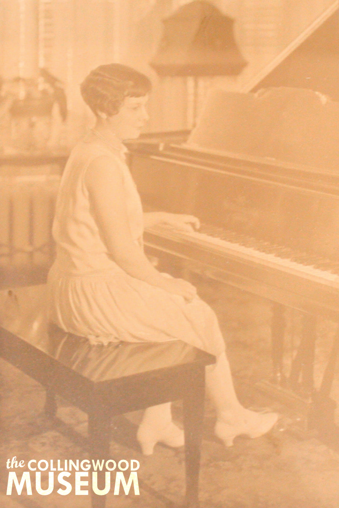 Photograph of a woman sitting at a piano