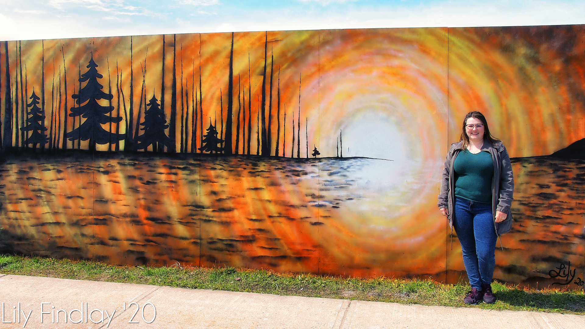 Mural of a woods silhouetted by the sunset