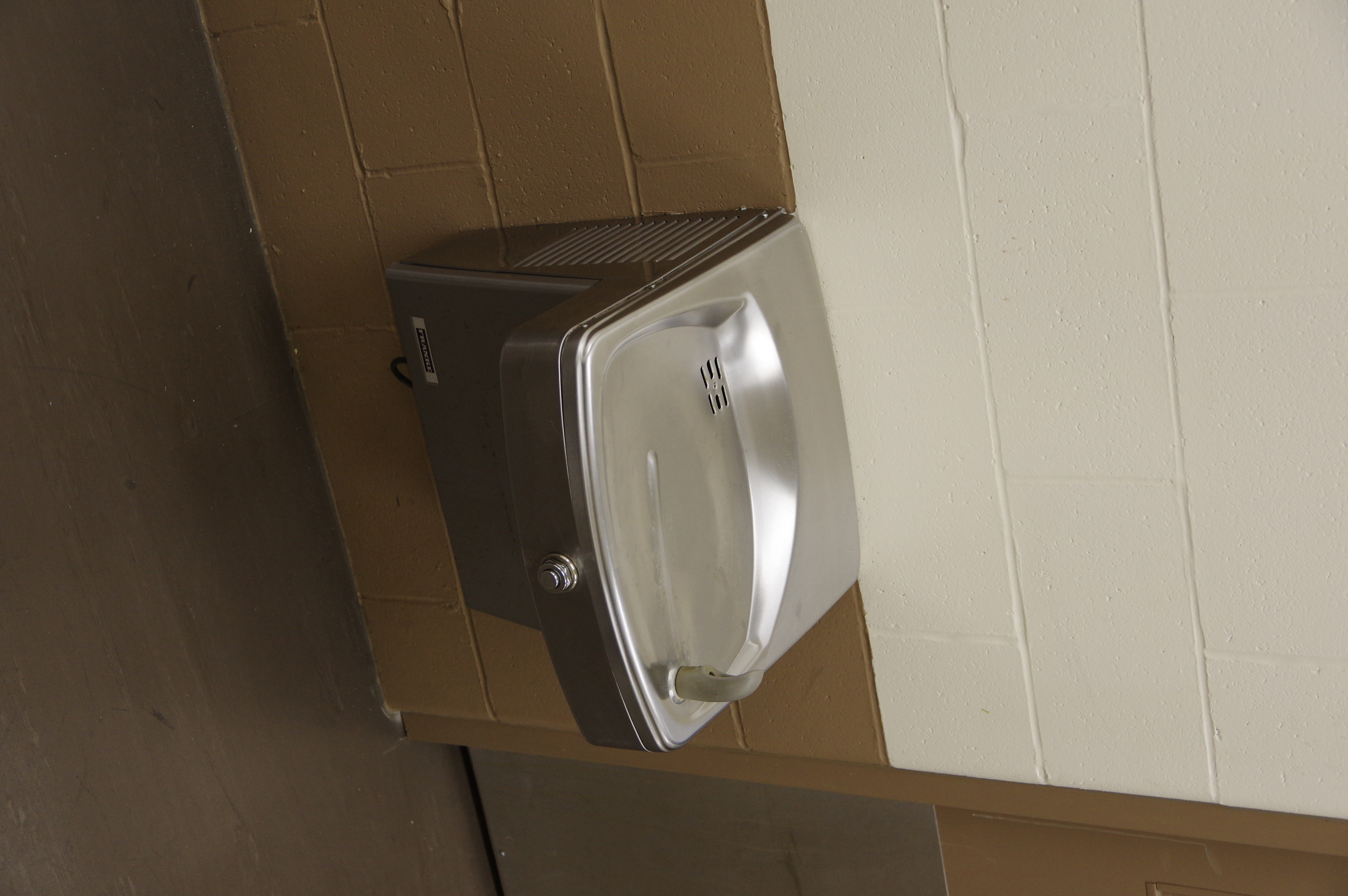 Located on the north side of the building outside of the change rooms.