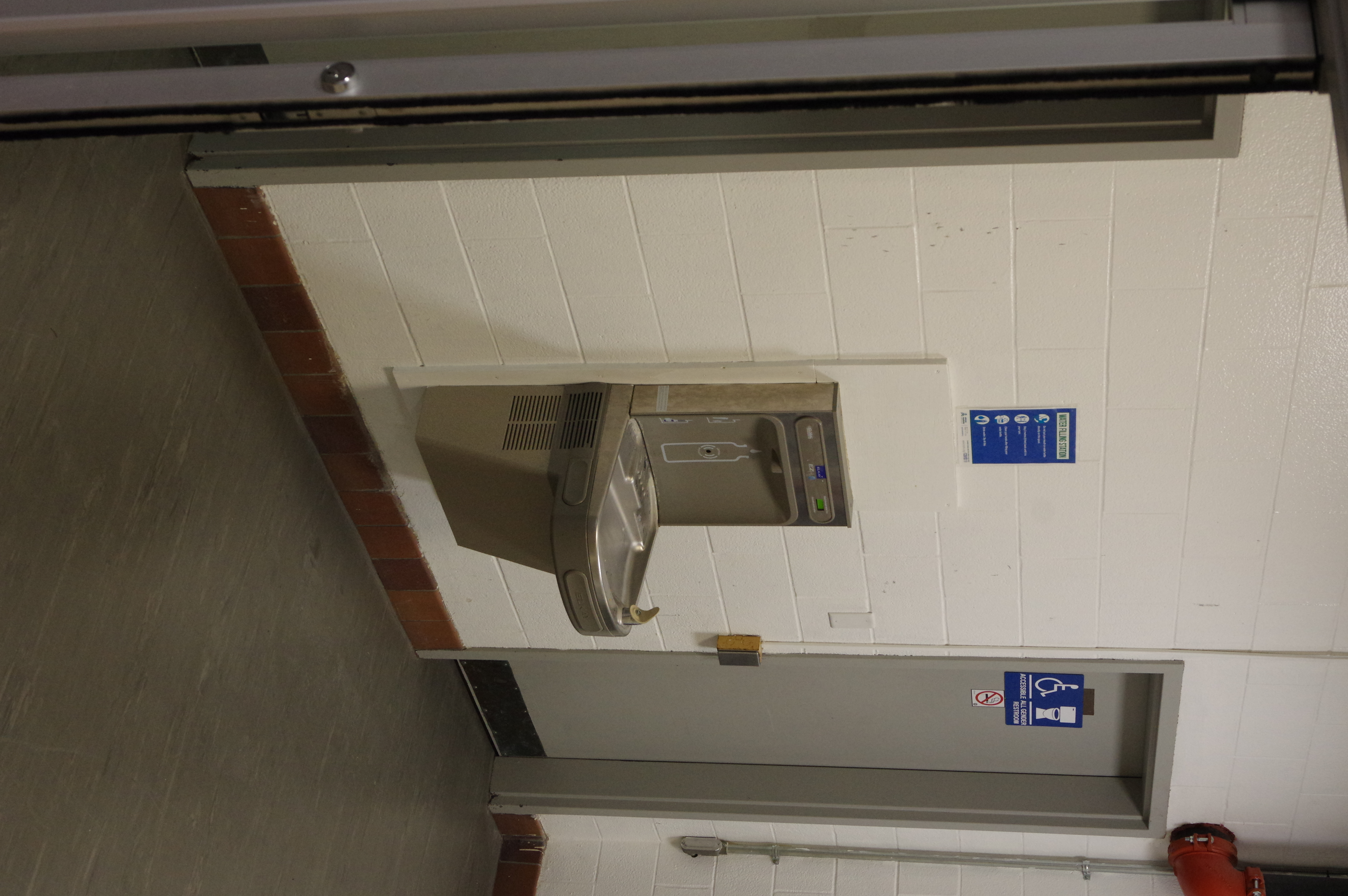 Inside the front entrance between the restrooms is the refill station.