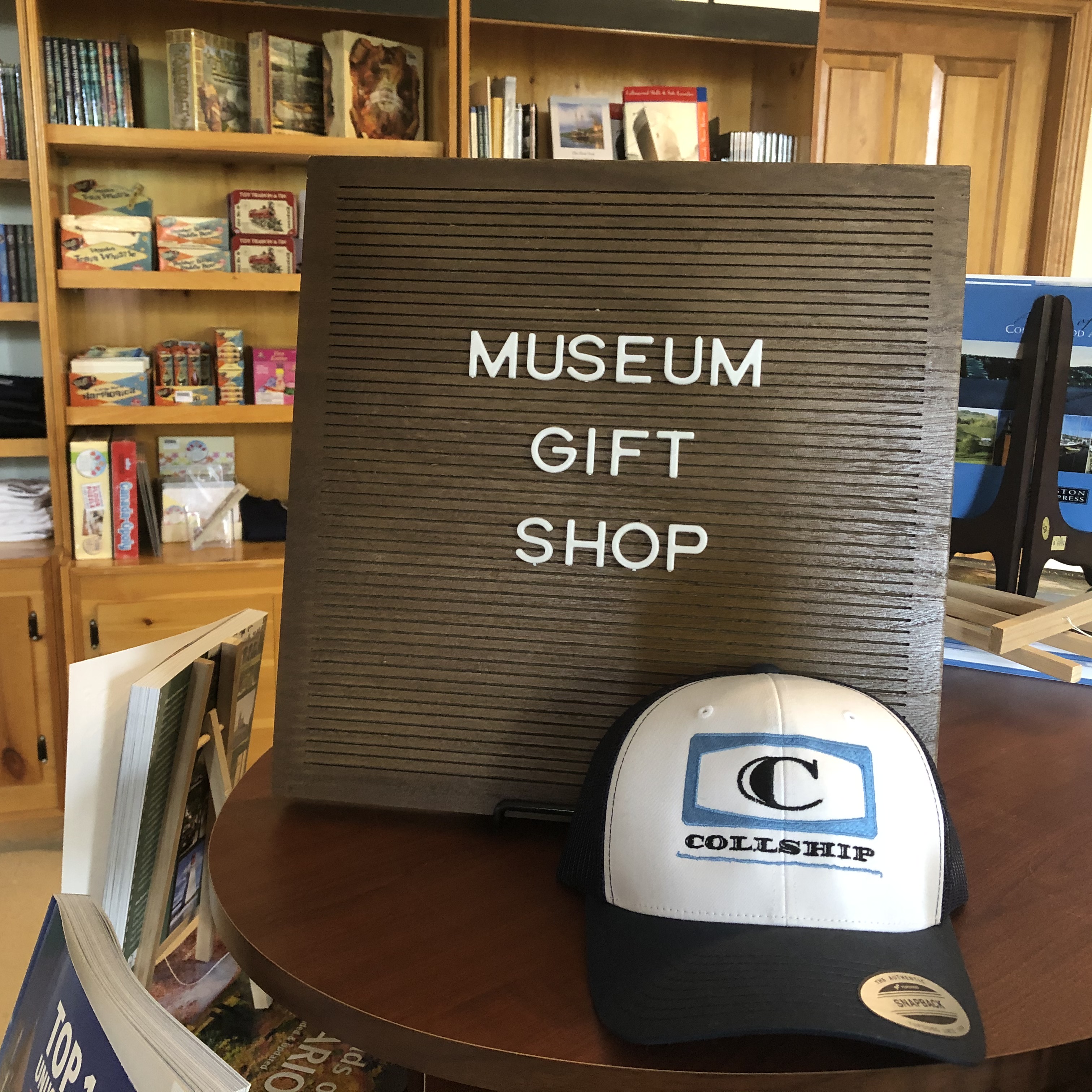 letterboard sign with words "Museum Gift Shop" and souvenier hat in front
