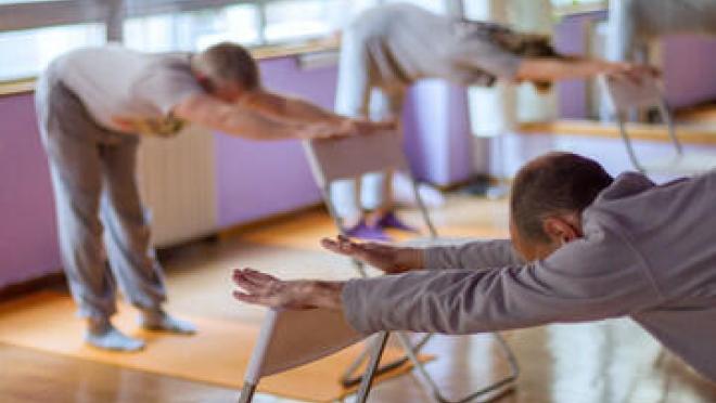 A group of people doing chair yoga