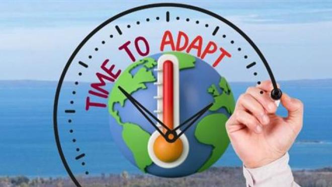 A globe with a thermometer inside a clock that says "TIME TO ADAPT." A hand draws the clock over a background of water and land.