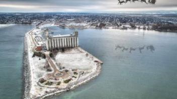 a snowy peninsula with santa and his reindeer flying above