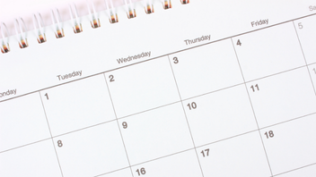 A close-up of a calendar page showing the days of the week and dates.