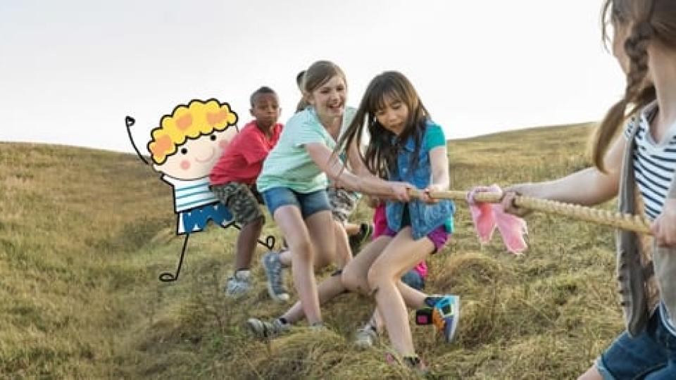 Children playing tug-o-war in an open field.