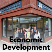 group of people posing for a photo outside of the business development centre