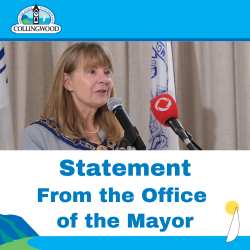 Statement from Mayor banner. There is a woman speaking into a red microphone.
