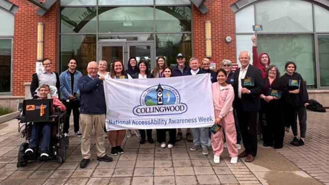 Group photo with National AccessAbility Week flag