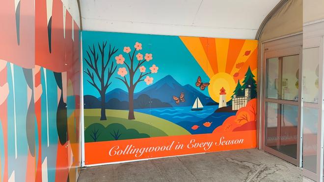 landscape mural with trees, water, a mountain, sun and grass