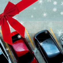 aerial image of 4 cars parked on an angle with red bow superimposed and graphic snowflakes