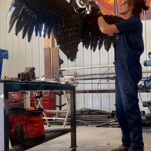 artist sculpting a metal owl