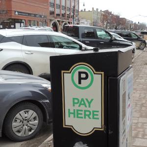 A Green P Municipal Parking meter and parked cars
