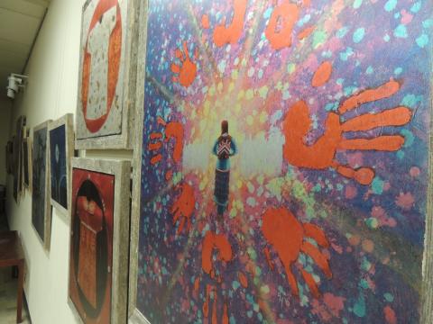 Indigenous artwork hanging on a wall in a gallery