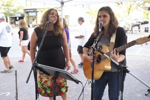 two musicians perform outside on the streets of downtown Collingwood