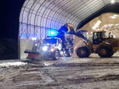 photo of a snowplow being loaded with sand