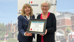 Mayor Hamlin and Margaret Mooy holding award certificate