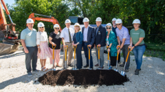 group photo of Collingwood Council, MPP Terry Dowdall, Warden Clarke and Affordable Housing Task Force Members with shovels in a pile of dirt