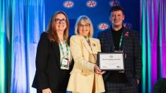 Councillor Doherty holding the Silver Designation award