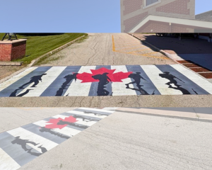 crosswalk painted with veteran sillhouette's